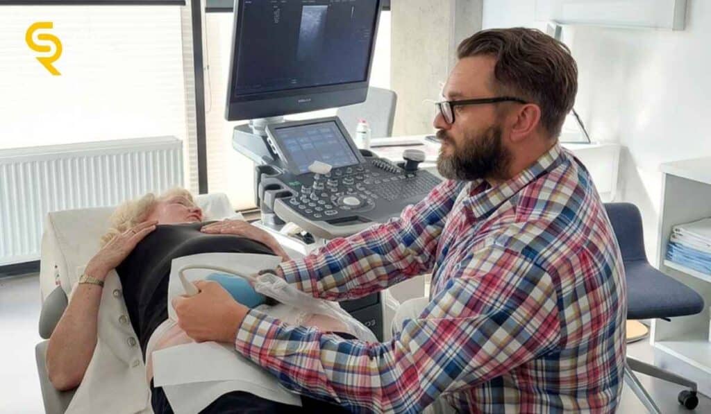Lekarz ortopeda wykonuje badanie USG u pacjentki z płynem w stawie biodrowym w CRS Clinic Warszawa
