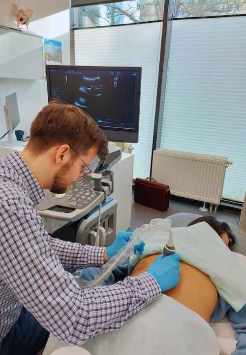 Lekarz neurochirurg wykonuje badanie USG przed kriolezja kręgosłupa