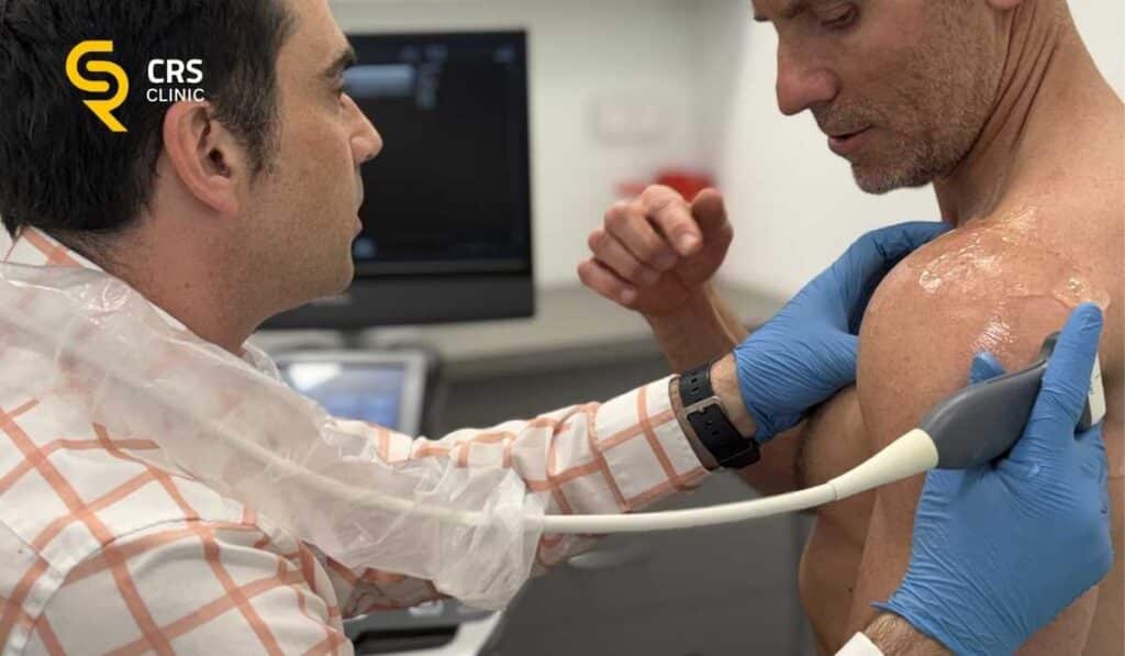Lekarz ortopeda przeprowadza diagnostykę i badanie USG zamrożonego barku u pacjenta w CRS Clinic Warszawa