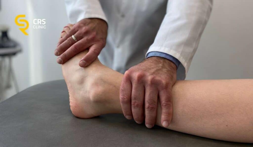Lekarz ortopeda wykonuje testy kliniczne przez zabiegiem sonochirurgicznym na ostrogę piętową w CRS Clinic Warszawa